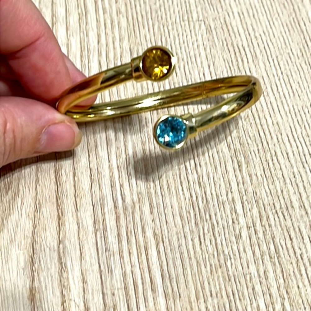 Citrine and topaz colored stones in gold wrap around bracelet